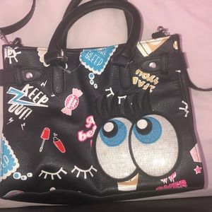 A black purse with different color words & images